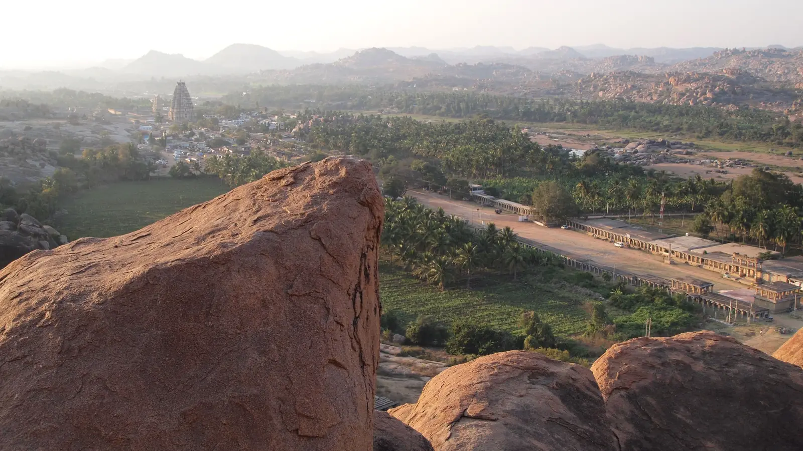 Granite boulder fields and Vijayanagara ruins at Hampi in evening light
